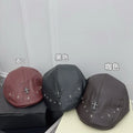 Cross-studded burgundy leather beret