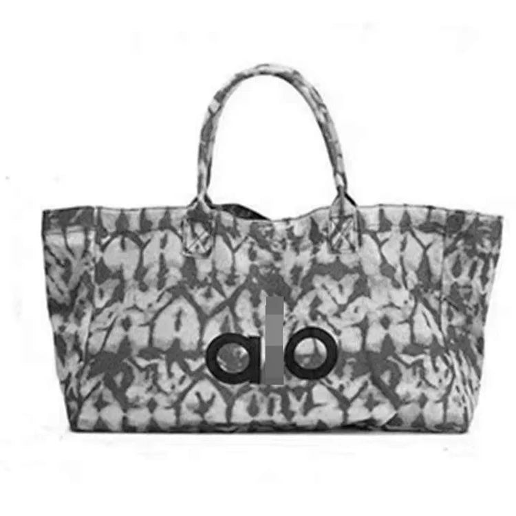 A signature shopping tote bag from Alo Yoga